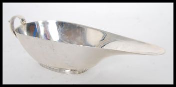 An early 20th Century hallmarked silver 1930's Art Deco elongated sauce boat / gravy jug by S