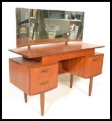 A vintage retro 20th century G-Plan teak mirror back dressing table. Raised on shaped supports