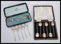 A silver hallmarked food pusher by Walker & Hall along with a set of six silver hallmarked tea