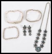 A selection of jewellery to include a stamped 925 flat woven silver bracelet, a stamped 925 rope