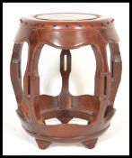 An early 20th Century Chinese hardwood garden seat / opium stool barrel of open form having