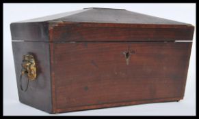 A Victorian 19th Century mahogany tea caddy in sarcophagus form, having lion head mask handles to