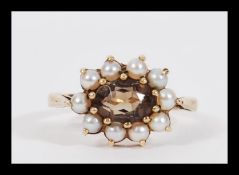 An early 20th Century hallmarked 9ct gold citrine and seed pearl ring having a central faceted