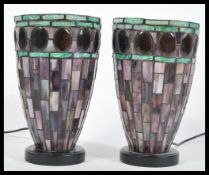 A pair of 20th Century Tiffany style leaded glass table lamps uplighter lights having purple glass