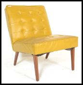A retro vintage 20th century yellow mustard bedroom chair having buton back and seat raised on
