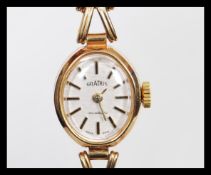 A hallmarked 9ct gold ladies Gradus wrist watch having a herringbone type 9ct gold watch bracelet.