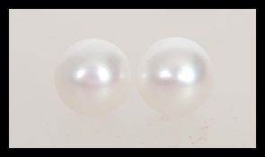 A pair of pearl earrings having 925 silver posts and backs. Pearl diameter approx 1cm.