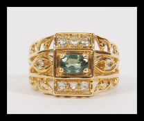 A vintage 20th Century hallmarked 9ct gold ring having large fret pierced shoulders with central