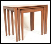 A vintage retro 20th Century Danish teak nest of three nesting tables raised on tapering blick