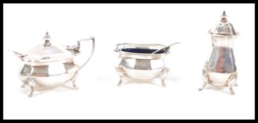 A matching set of three early 20th Century hallmarked silver condiments by Alexander Clark & Co