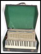 A vintage retro 20th Century large piano accordion by Itala having mother of pearl decoration with