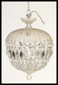 An early 20th Century large glass crystal chandelier hanging light fixture having multiple strands