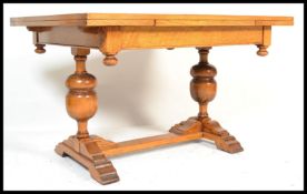 An early 20th century, circa 1930's  light oak draw leaf dining table raised on bulbous baluster