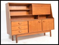 A retro 20th Century teak wood highboard sideboard credenza, being raised on square supports