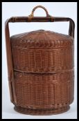 An early 20th Century large Chinese bamboo and wicker sectional steamer box of cylindrical form