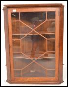 A 20th Century mahogany corner wall display cabinet, having a sectional glazed door with two shelves