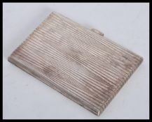 A silver white metal tests as silver cigarette case having a bark effect / backgammon type design to