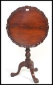 An 18th century style mahogany birdcage tilt top occasional / wine table. Raised on splayed legs