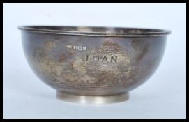 A 20th Century hallmarked silver bowl raised on a circular foot with Asprey London 1585 stamped to