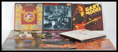 A collection of Rock vinyl long play LP records featuring multiple AC / DC, Thin Lizzy, Deep Purple,