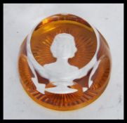 A vintage 20th Century Baccarat paperweight in amber glass having a cameo portrait of a lady to