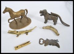 A group of antique and vintage brass ware to include a brass clothes peg, brass horse, brass dog