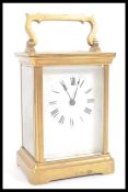 A 19th Century French gilt brass carriage clock having a white enamel face with Roman numeral