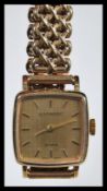 A vintage Garrard 9ct gold ladies watch set to a 9