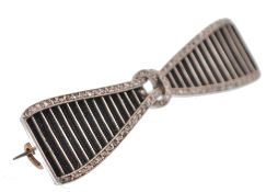 An early 20th century white and yellow gold bow brooch pin. The brooch having plated hair inlay with