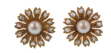 A pair of gold pearl and diamond earrings. The earrings being designed in the form of a flower