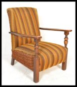 A vintage 20th Century open framed fireside armcha