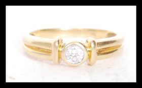 A stamped 18ct gold solitaire ring bezel set with