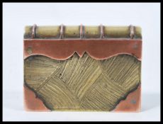 An early 20th Century brass and copper lighter in