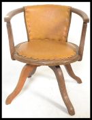 An early 20th Century industrial oak captains swivel armchair. The chair being raised on quadruped