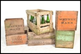 A collection of vintage 20th Century advertising bottle crates, crates to include Watneys, Kio Ora