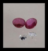 A selection of loose precious stones to include a round brilliant cut diamond, a heart cut diamond