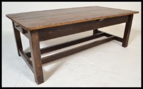 A 19th Century Victorian farmhouse dining table with a single fitted drawer raised on shaped