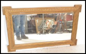 A Victorian 19th Century gilt overmantel mirror of rectangular form having inset glass mirror,