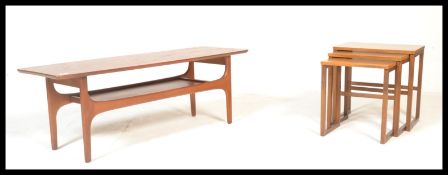 A retro 20th Century teak wood coffee table, surfboard shaped top raised on tapering supports united