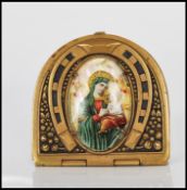 A 20th Century brass vesta case of domed form having repousse decoration of a horseshoe with an oval