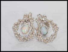A pair of stamped 925 silver drop earrings having cz accent stones with central panelled opalite