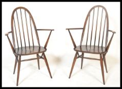 A pair mid 20th Century Ercol beech and elm carver dining chairs in the quaker  pattern. Spindle