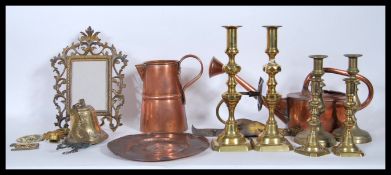 A collection of vintage and antique copper and brass metal wares to include a copper plate in the