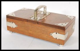 An Edwardian early 20th Century oak two section humidor, having two hinged lids opening to reveal