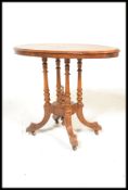 A Victorian 19th century walnut and mahogany oval tilt top loo / breakfast table.  Raised on a