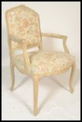 A Louis XVI style Fauteuil armchair, upholstered in with a pale fabric decorated with fruit and