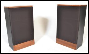 A pair of 20th Century Advent Legacy II floor standing audio speakers the speakers within elm
