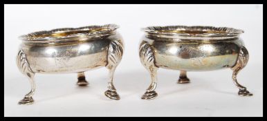A pair of 19th Century silver hallmarked table salt condiments raised on three cab feet with