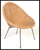 A vintage retro 20th Century wicker satellite sputnik atomic chair raised on ebony tubular legs