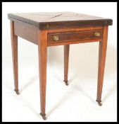 An early 20th Century Edwardian rosewood inlaid envelope card table. Of square form with fold over